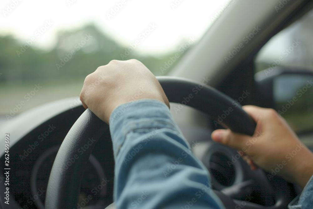 Close up of Hands Driving Car Concept