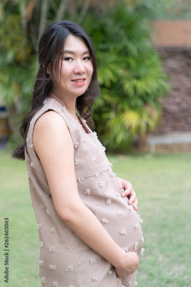 Pregnant woman resting in garden. Pregnant woman resting in garden.