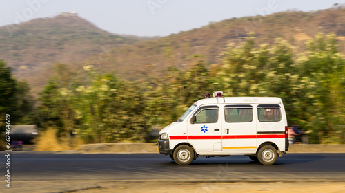 An ambulance on an Indian road travelling at high speed near Mumbai suburban 