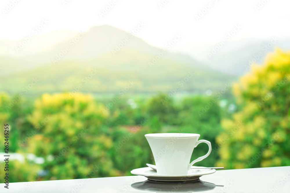 White glass of coffee with mountain and natural background at sunrise, beverage in relaxing White glass of coffee with mountain and natural background at sunrise, beverage in relaxing