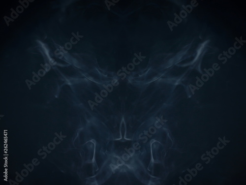 smoke abstract texture , magical scary devil fire at night . scream of ghost horror in halloween . symmetry fractal swirl gas in the air