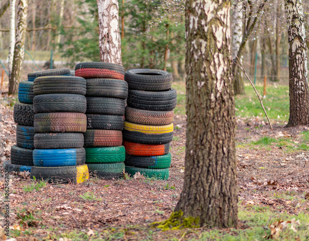 Old used car tires left, dumped in the forest, environmental concept