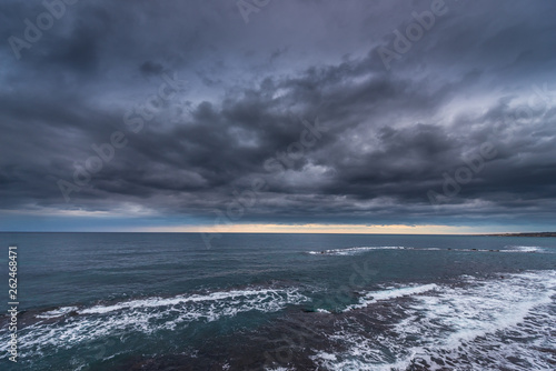 Cloudscape over Ionian Sea. View from Ortygia isle, Syracuse city, Sicily Island in Italy