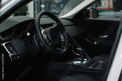 black steering wheel near gear shift handle in luxury car © LIGHTFIELD STUDIOS