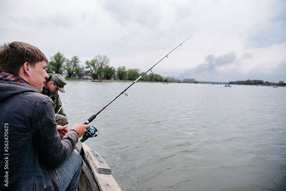Fishermen catch fish sitting in the boat Fishermen catch fish sitting in the boat