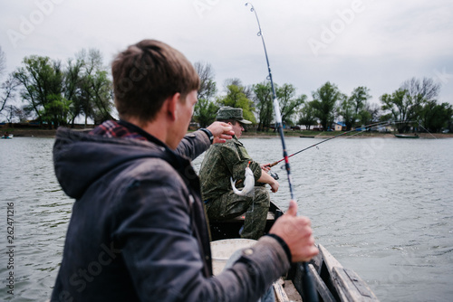 Fishermen catch fish sitting in the boat