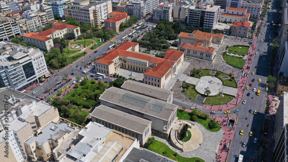 Aerial drone photo of trilogy neoclassic buildings, Academy of Athens, University and public library and Lycabettus hill at the background, Athens, Attica, Greece