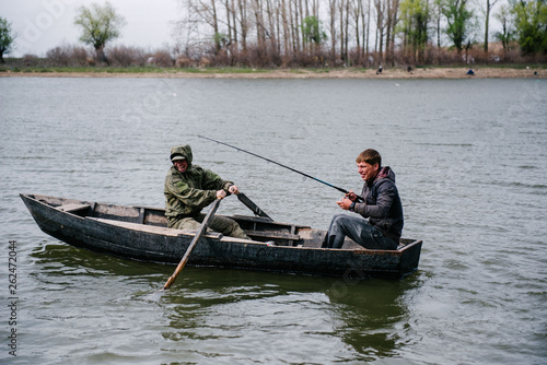 Fishermen catch fish sitting in the boat