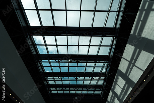 Glass ceiling in a shopping mall with a bright sun outside