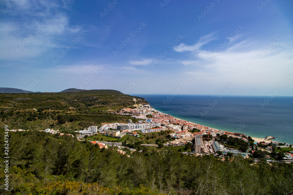 aerial view of Sesimbra village with blue sky and clouds in background