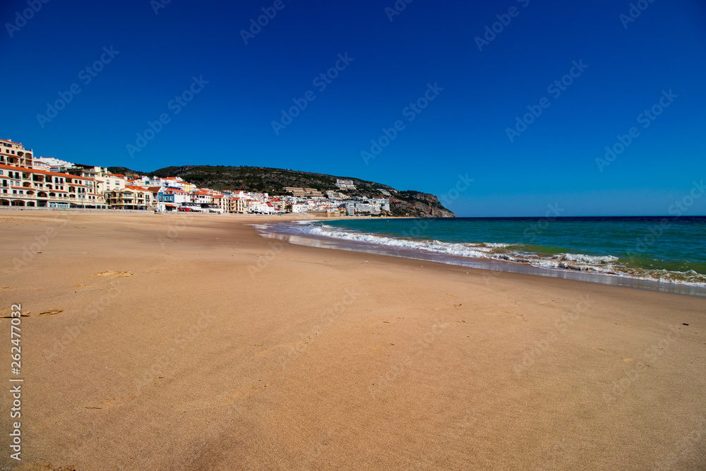 Gold beach in Sesimbra with sand in the foreground