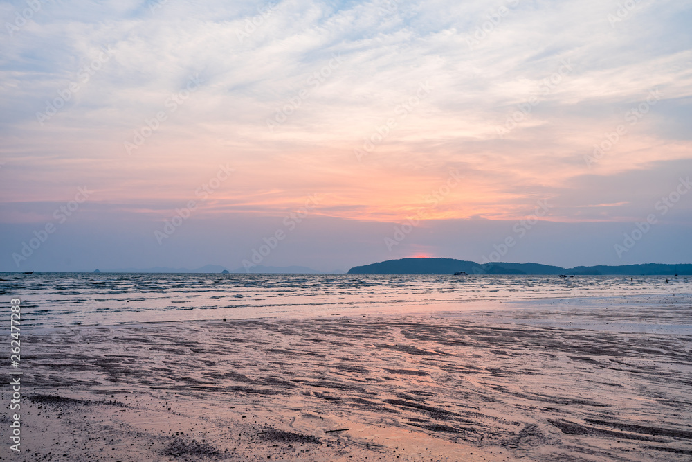Panoramic photo of beautiful sunset over the sea with cloudy blue and orange sky