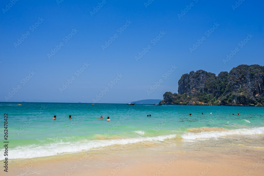 Railay Beach. People are swimming in water