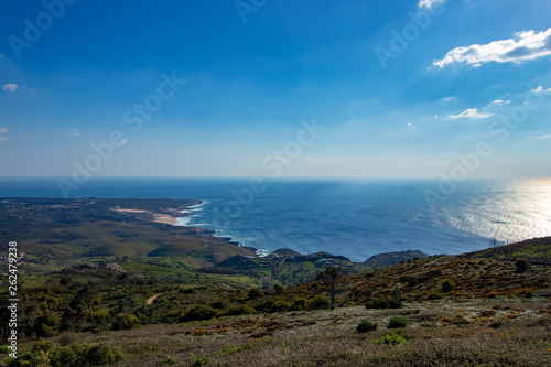 Green mountain with the sea in horizon