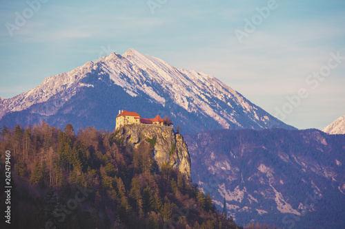 View of Bled Castle against snowy mountains from Bled lake