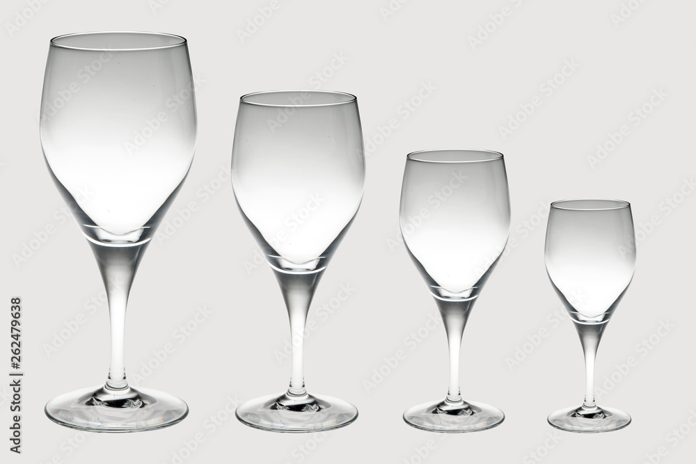 four crystal wine glasses in decreasing size isolated on white background four crystal wine glasses in decreasing size isolated on white background