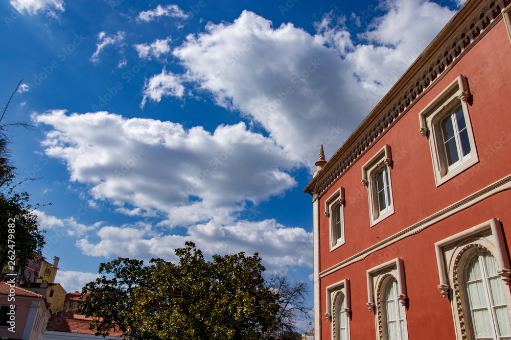 Fototapeta premium old house with blue sky and white clouds standing out above