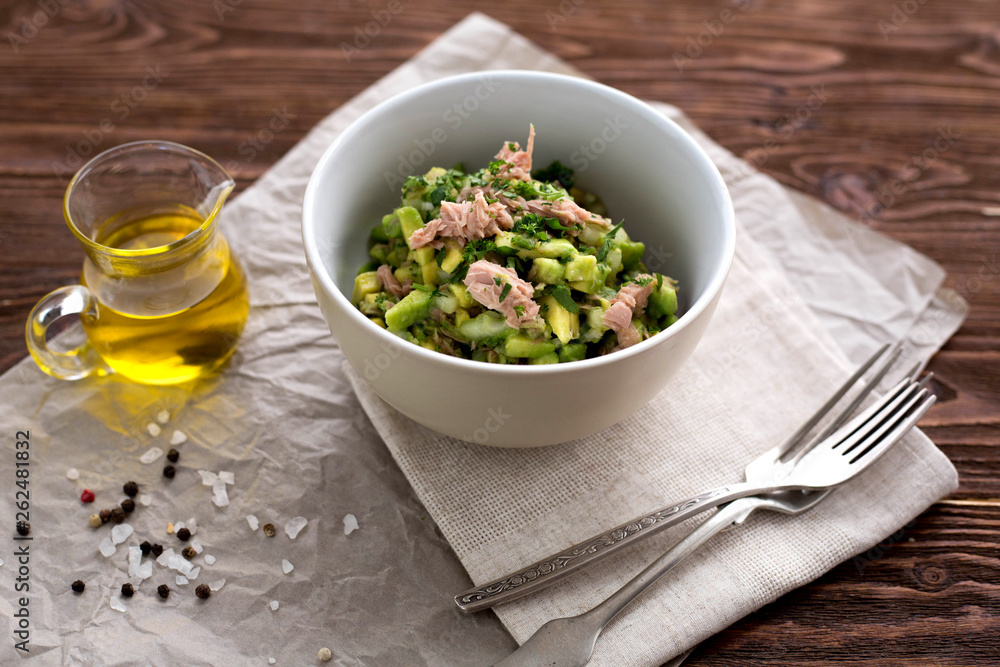 Salad with tuna, avocado, salt,  parsley and lemon. Top view. Organic. Vitam. Healthy food. Homemade. Wooden table. Paleo diet.