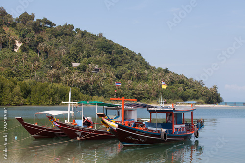 Colorful boats with flags on Koh Samui. Transport on island.