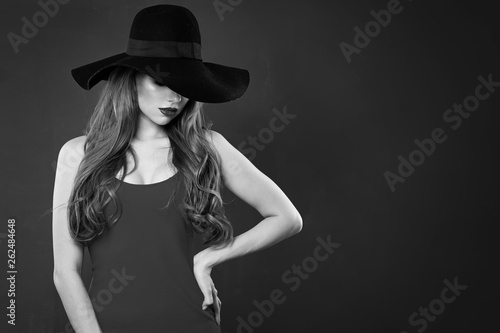 Retro style portrait of beautiful woman model in hat. Black and white photo