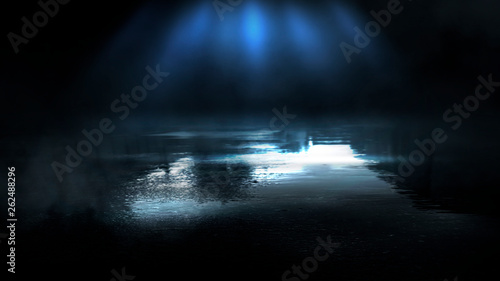 Dark street and wet asphalt. Night view of the city, reflection of the glare in the water, neon blue light. Dark street background. © MiaStendal
