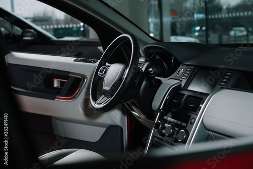 buttons near black steering wheel in luxury car