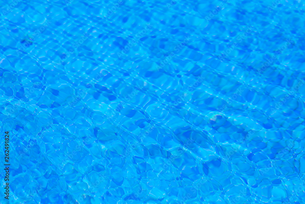 water ripples in swimming pool, blue background