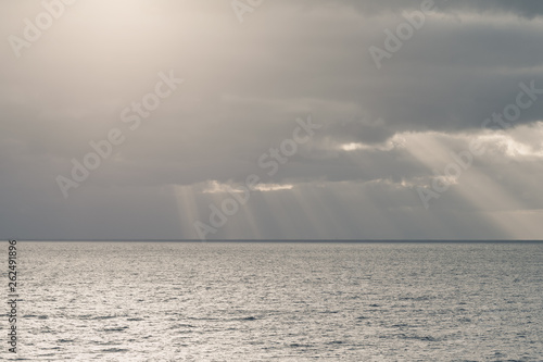 cloudy sky with sun rays in the open sea