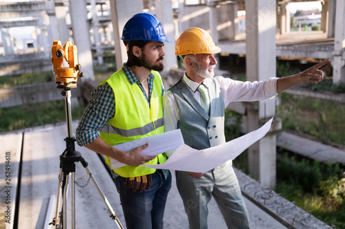 Fotografija Engineer, foreman and worker discussing in building construction site