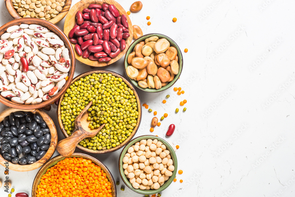 Legumes, lentils, chikpea and beans assortment on white.