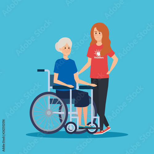 girl volunteer with old woman in the wheelchair