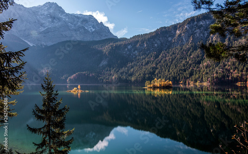 Fototapeta Naklejka Na Ścianę i Meble -  Impressive Nature Landscape. The Eibsee Lake in front of the Zugspitze under sunlight reflected in water.