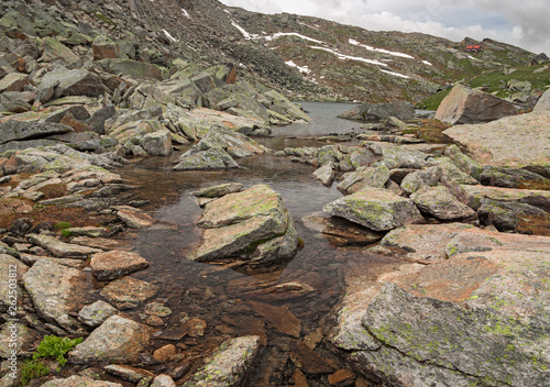 Alpine ponds in view of the Rifugio Città di Chivasso at Col del Nivolet, in the Gran Paradiso park, Italy.