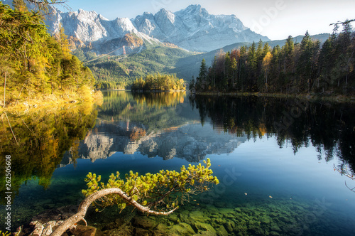 Fototapeta Naklejka Na Ścianę i Meble -  Incredible Autumn landscape The Eibsee Lake in front of the Zugspitze under sunlight. Amazing sunny day on the mountain lake. top place for photography. Eibsee lake in Bavaria, Germany