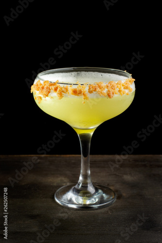 Cocktail with orange zest and whipped frothy.