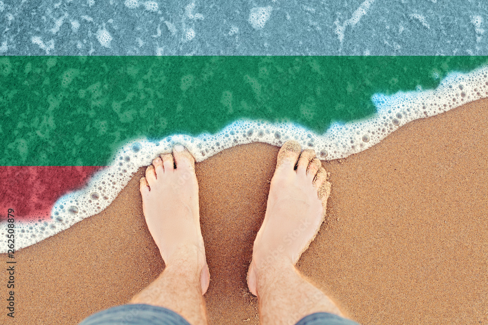 Fototapeta premium Surf on sandy beach with flag Bulgaria. Top view