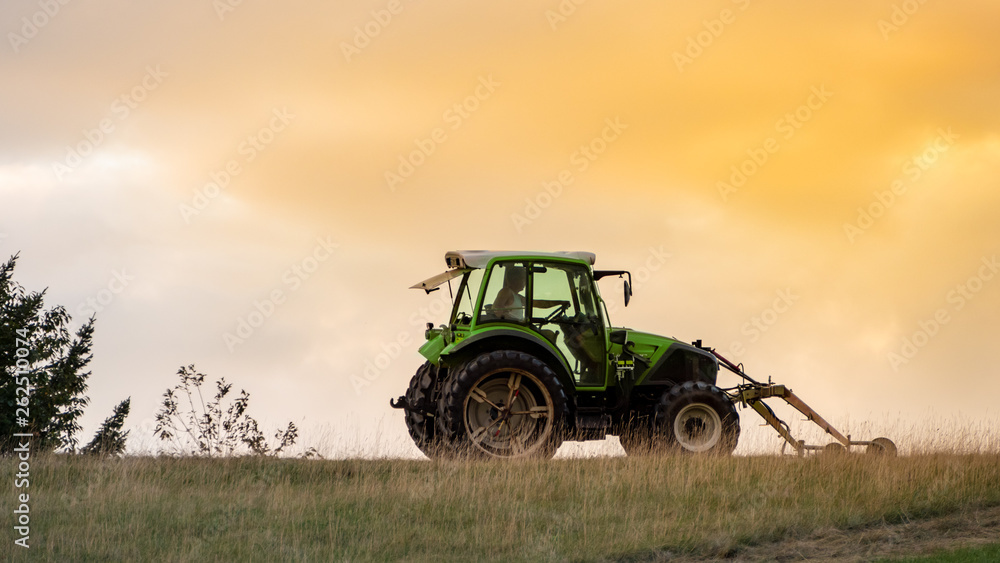 Fototapeta premium tractor in the evening sky