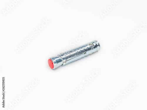 Zinc plated steel wall plug for metric screw bolt shot on white.