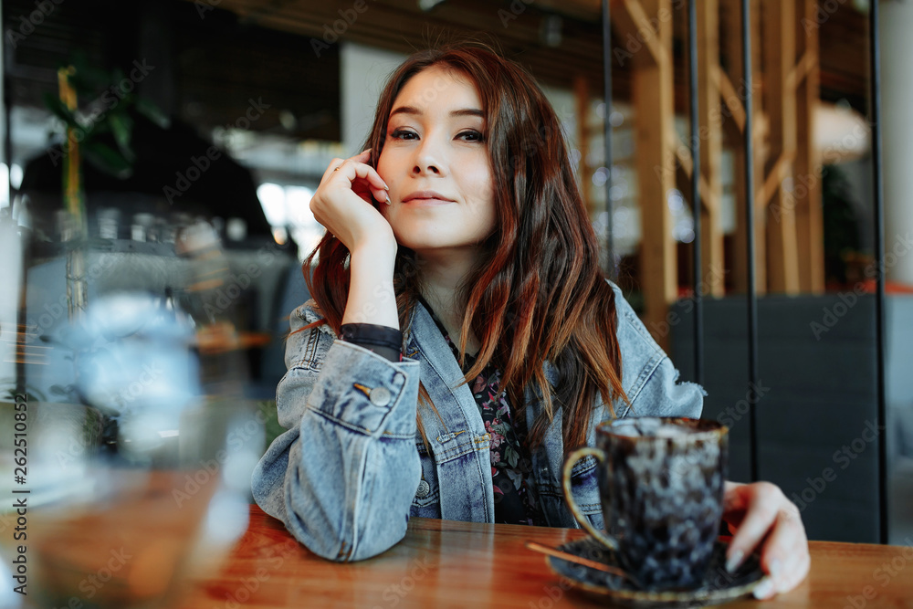 Portrait of Asian woman smiling in coffee shop cafe