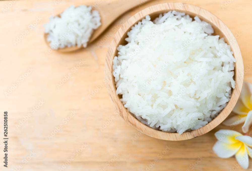 Close up white rice in wooden bowl with spoon, healthy food, selective focus Close up white rice in wooden bowl with spoon, healthy food, selective focus