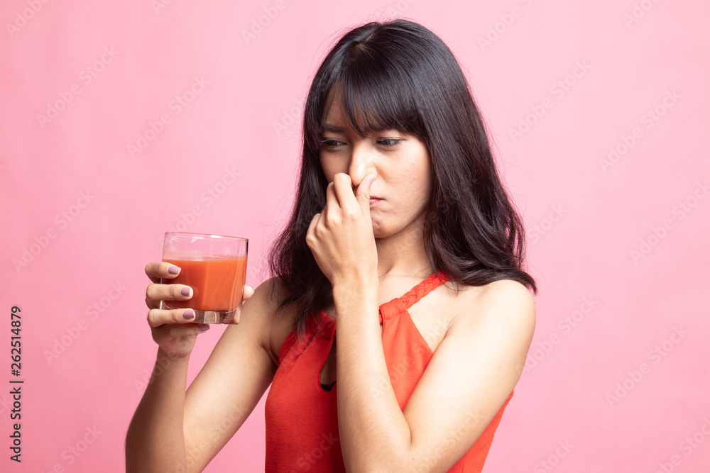 Young Asian woman hate tomato juice. Young Asian woman hate tomato juice.