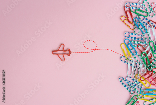 Business concept for group of stacked paperclip with another one red plane paperclip is point to another direction as a team leadership photo