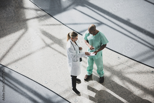 Overhead shot of medical professionals discussing results in a hospital