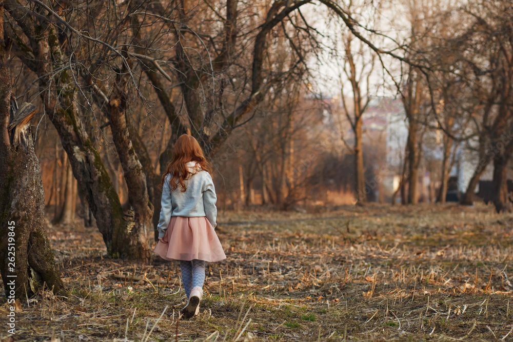 Red-haired girl with freckles in a park. Spring or Autumn. Happy carefree childhood. Red-haired girl with freckles in a park. Spring or Autumn. Happy carefree childhood.