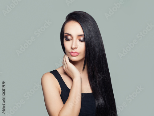 Young perfect woman with long dark straight hair and makeup portrait
