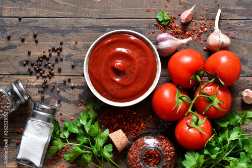 Tomato ketchup sauce with spices and pepper. View from above.