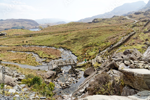 Wooden bridge on the Cwmorthin Waterfall trail in the mountains of Snowdonia National Park, Wales.