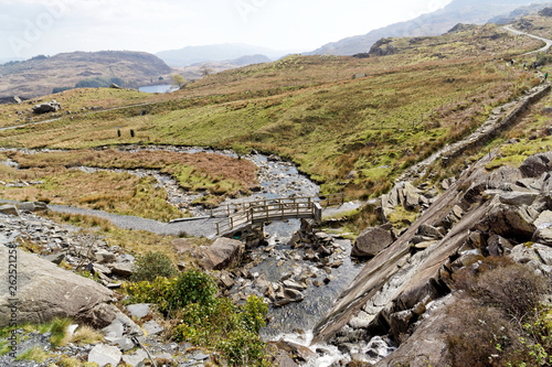 Wooden bridge on the Cwmorthin Waterfall trail in the mountains of Snowdonia National Park, Wales. photo