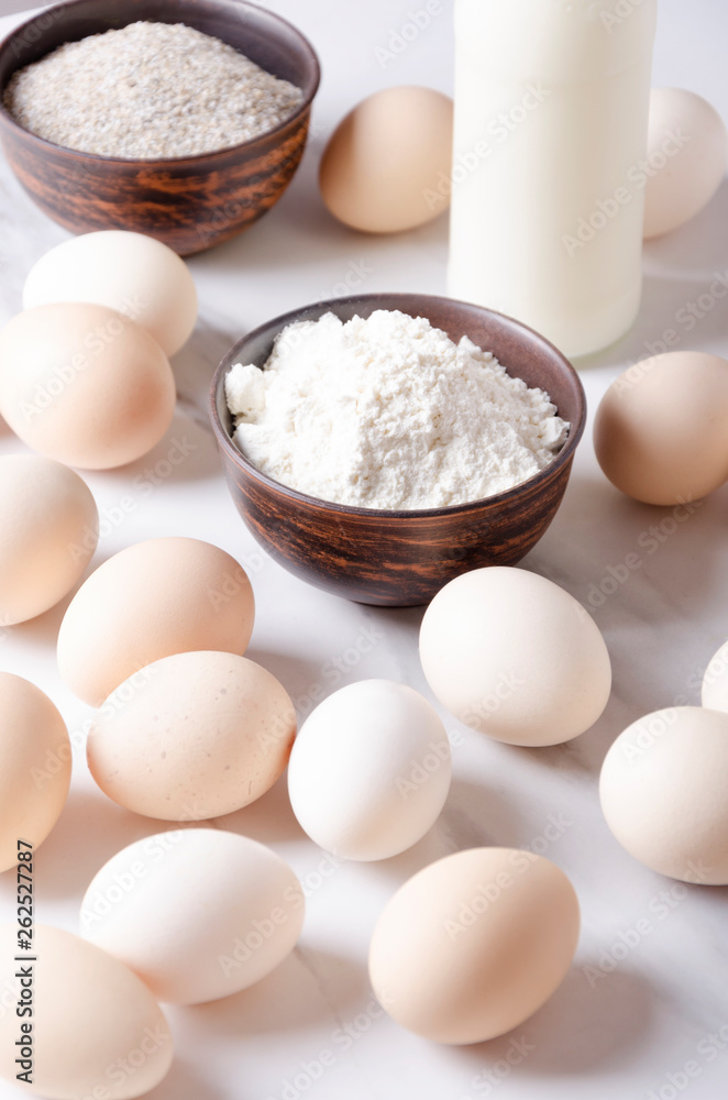 Ingredients for making dought.Eggs, flour and bottte of milk.Preparation for cooking bakery products Ingredients for making dought.Eggs, flour and bottte of milk.Preparation for cooking bakery products