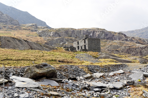 Ruins of a stone house on the Cwmorthin Waterfall trail in the mountains of Snowdonia National Park, Wales. photo